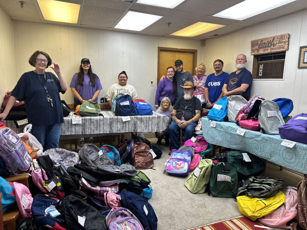 group of people with backpack donations for children
